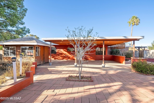 exterior space with an outbuilding and stucco siding