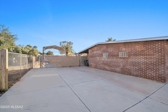 view of patio featuring fence and a gate