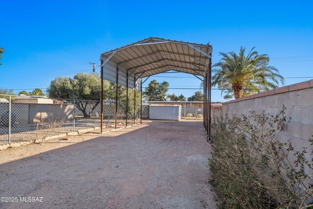 5822 E S Wilshire Dr, Tucson, AZ 85711 - view of parking featuring a detached carport and fence
