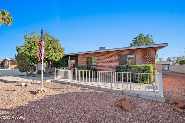 single story home featuring brick siding and fence