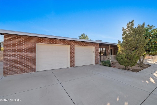 view of front of home with brick siding, concrete driveway, and an attached garage