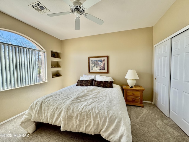 bedroom with visible vents, a ceiling fan, a closet, carpet floors, and baseboards