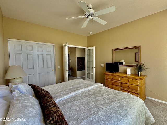 bedroom with a closet, baseboards, a ceiling fan, and carpet flooring