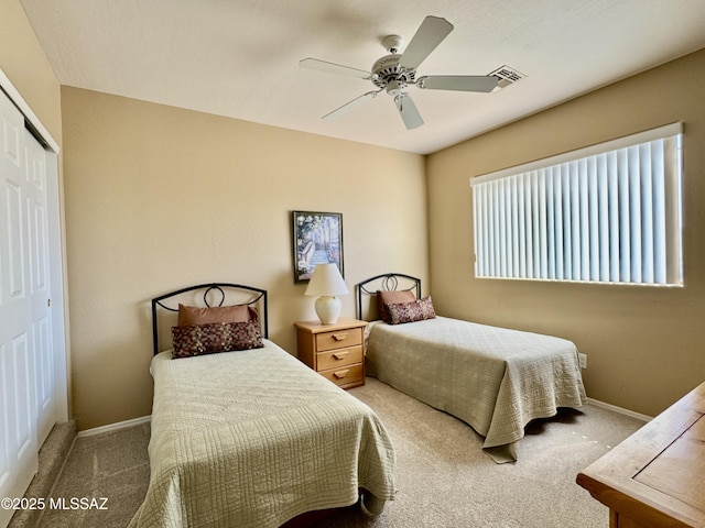 bedroom featuring visible vents, a ceiling fan, a closet, carpet flooring, and baseboards