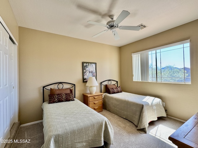 bedroom with baseboards, a closet, carpet floors, and visible vents