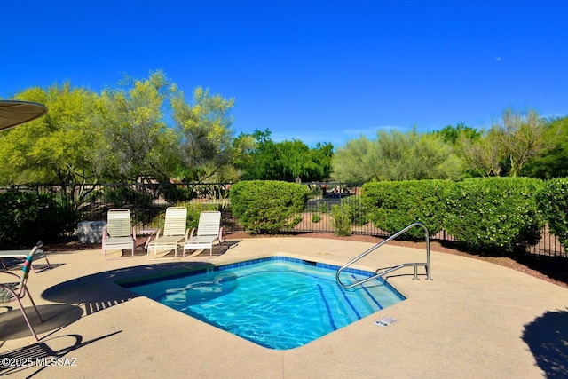 view of swimming pool with a swimming pool, a patio, and fence
