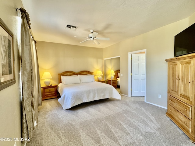 bedroom with visible vents, baseboards, light colored carpet, and ceiling fan