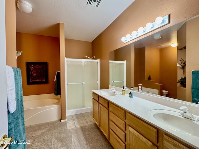 bathroom with visible vents, a stall shower, and a sink