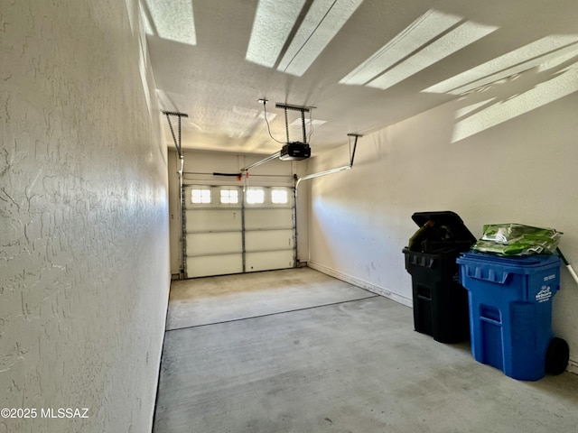 garage with a garage door opener and a textured wall