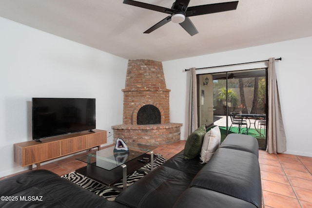 tiled living room featuring a brick fireplace and a ceiling fan