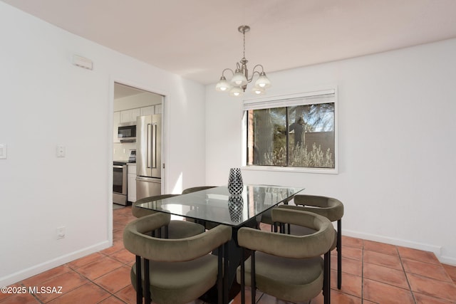 dining space with tile patterned floors, baseboards, and an inviting chandelier