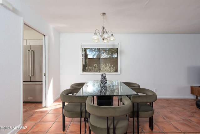 tiled dining room featuring baseboards and an inviting chandelier