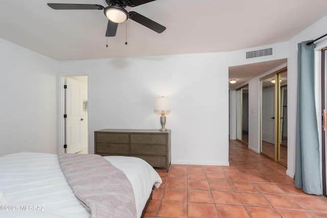 bedroom featuring light tile patterned floors, baseboards, visible vents, and a ceiling fan