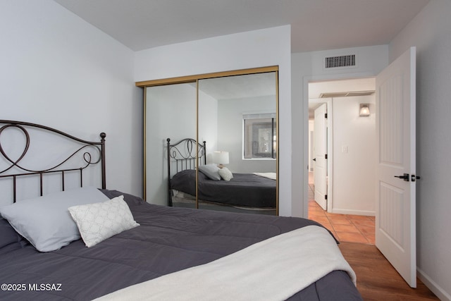 bedroom with a closet and visible vents