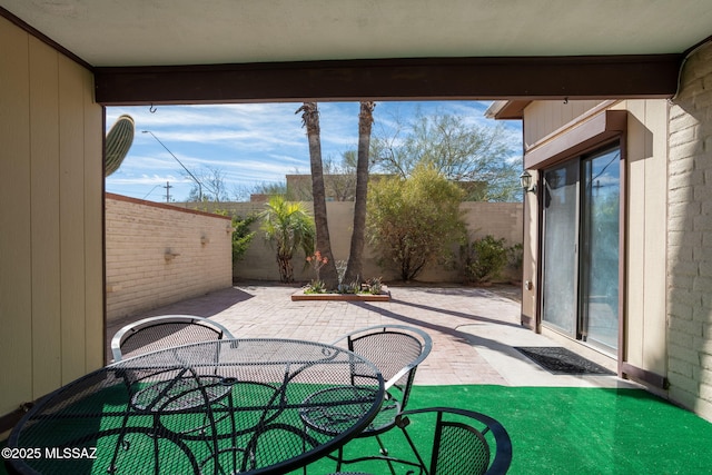 view of patio featuring outdoor dining area and a fenced backyard