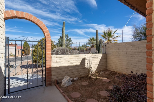 exterior space featuring fence private yard and a gate