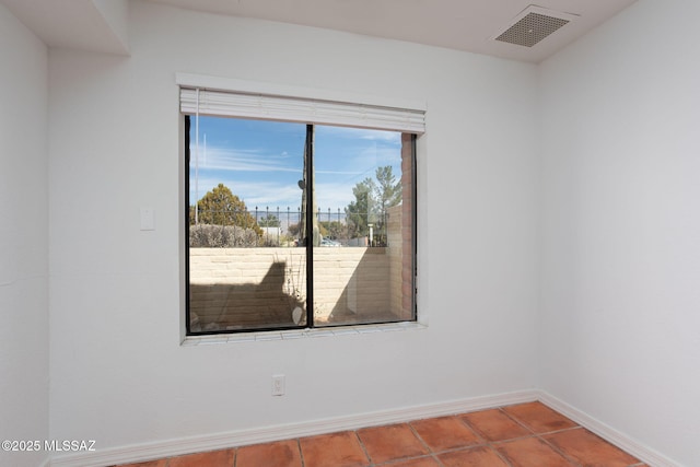 unfurnished room with tile patterned flooring, visible vents, and baseboards