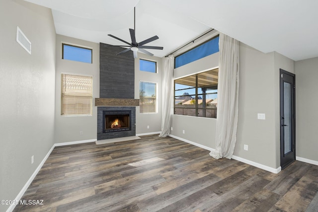 unfurnished living room featuring baseboards, a fireplace, visible vents, and dark wood-type flooring