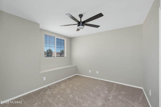 spare room with ceiling fan, carpet flooring, and baseboards