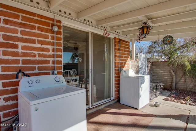 exterior space with a patio area, brick siding, and fence