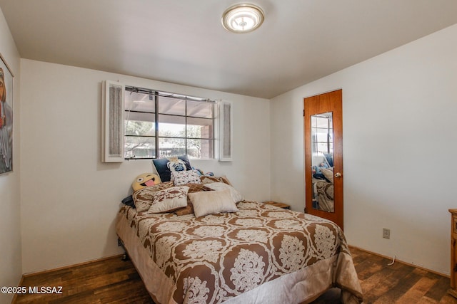 bedroom featuring dark wood-style flooring