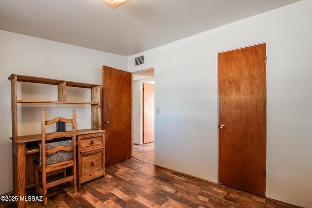 office space with dark wood-style floors and visible vents