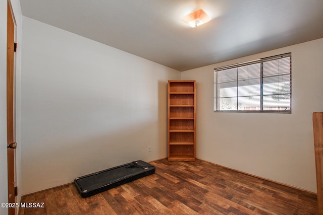 exercise area with dark wood-type flooring