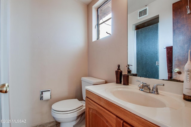 bathroom with visible vents, vanity, and toilet