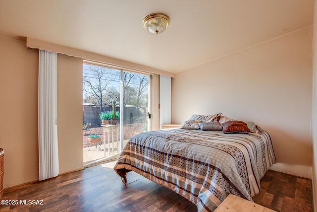 bedroom with access to outside and dark wood finished floors