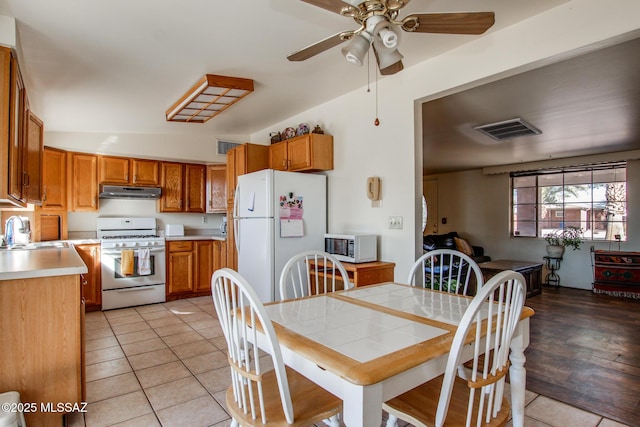 dining space featuring a ceiling fan, visible vents, and light tile patterned floors