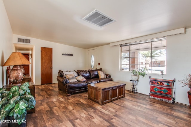 living area with visible vents and dark wood-type flooring