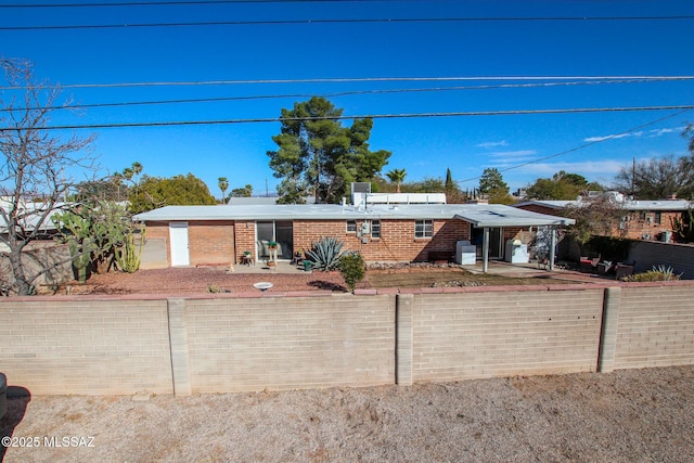 view of front facade featuring a fenced front yard and brick siding