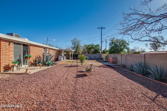 view of yard featuring a patio area and a fenced backyard