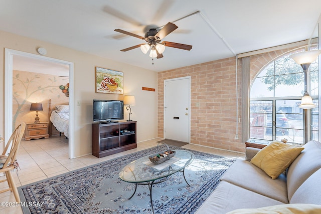 living room with light tile patterned floors, brick wall, and ceiling fan