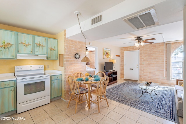 kitchen with white electric stove, light tile patterned flooring, under cabinet range hood, visible vents, and green cabinets