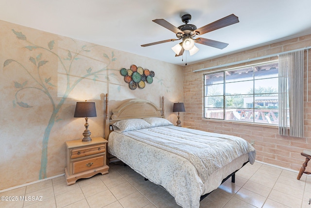 bedroom with brick wall, a ceiling fan, and light tile patterned flooring