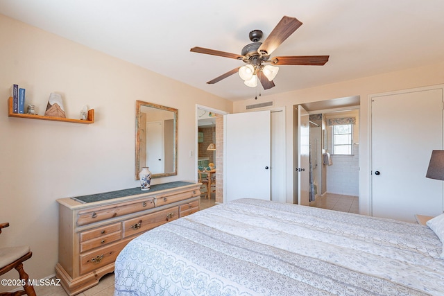 bedroom with ceiling fan, visible vents, and ensuite bathroom