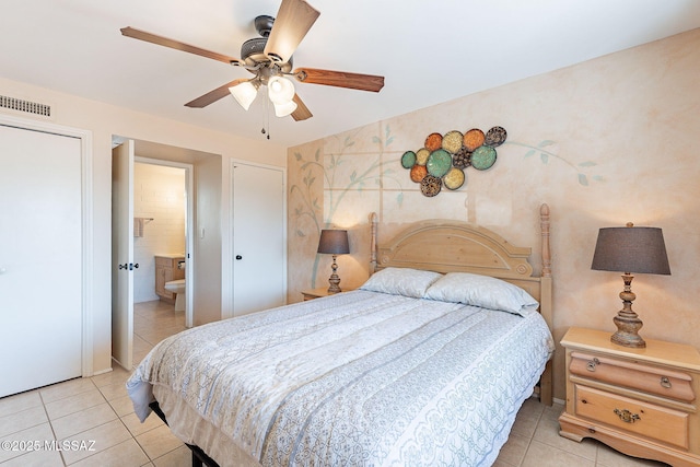 bedroom with wallpapered walls, visible vents, connected bathroom, ceiling fan, and light tile patterned flooring