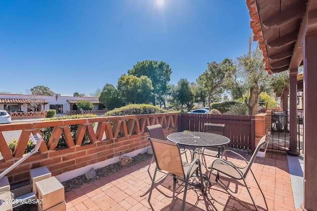 view of patio with fence and outdoor dining area