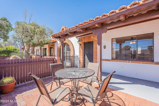 view of patio with outdoor dining space and fence