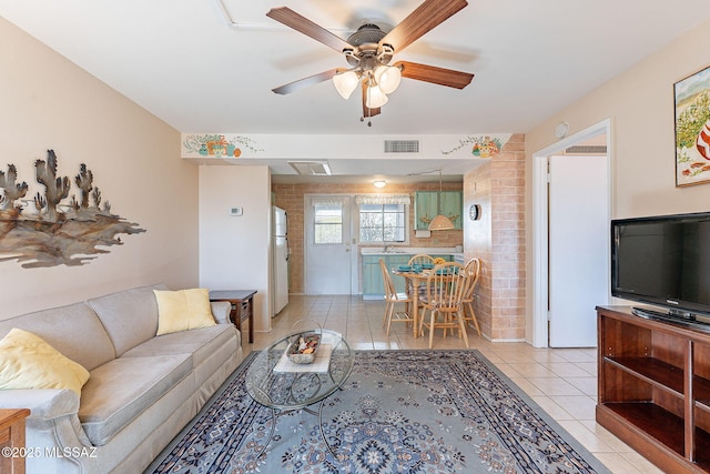 living room with light tile patterned floors, ceiling fan, and visible vents