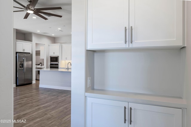 30776 S Sand Hurst Ln, Oracle, AZ 85623 - kitchen with stainless steel appliances, recessed lighting, white cabinetry, wood finished floors, and a sink