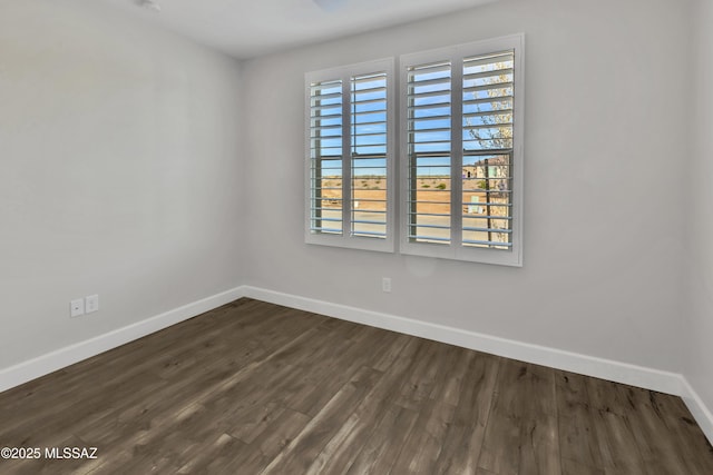 30776 S Sand Hurst Ln, Oracle, AZ 85623 - empty room featuring baseboards and dark wood-type flooring