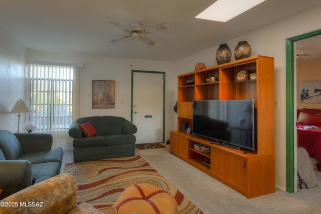 living room featuring light carpet and a ceiling fan