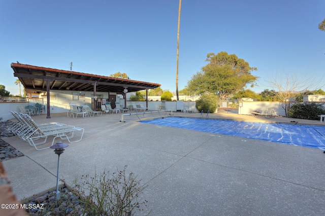 community pool featuring a patio area and fence