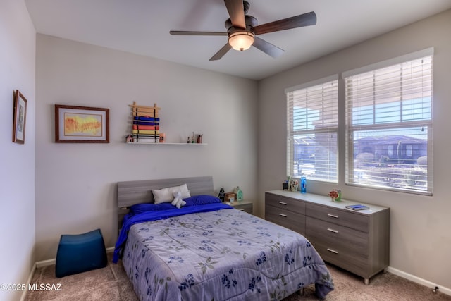 bedroom with light colored carpet, baseboards, and ceiling fan