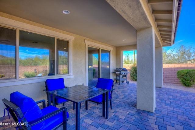 view of patio / terrace featuring a grill and fence