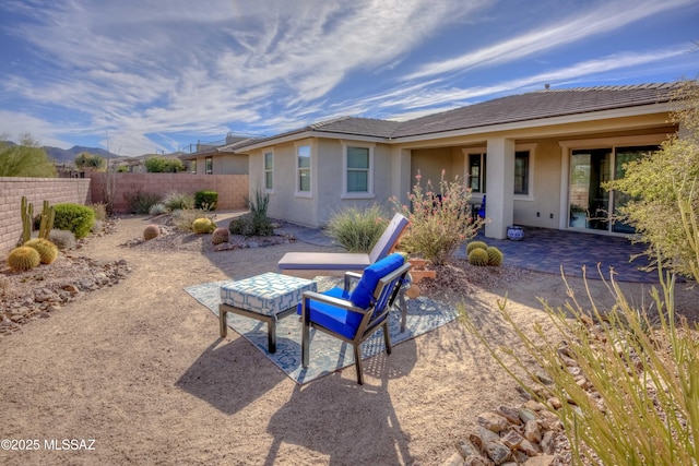 back of house featuring stucco siding, a patio, and fence