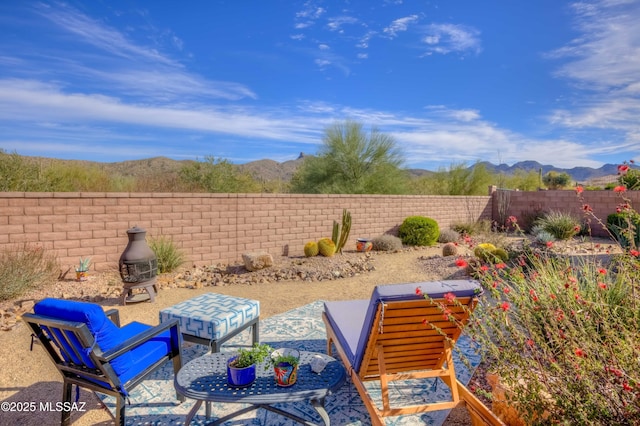 view of patio featuring a fenced backyard and a mountain view