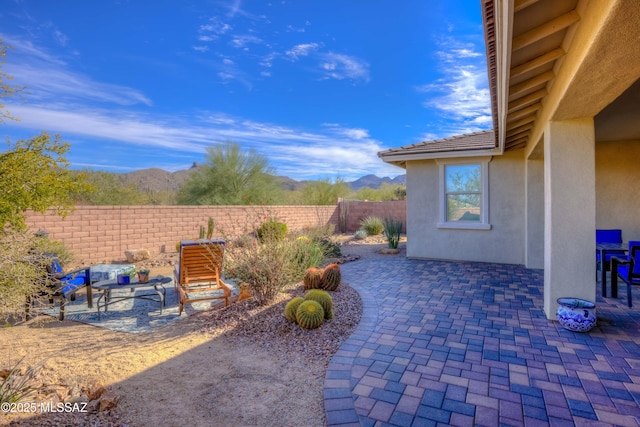 view of patio featuring a fenced backyard and a mountain view